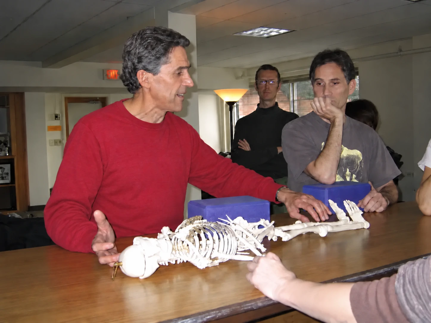 Sam Dworkis teaching anatomy with a skeleton